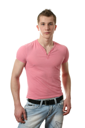 man in pink tshirt and light blue jeans looking at the camera